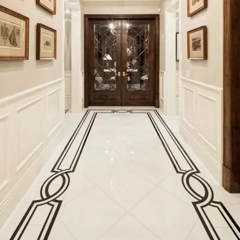 Light marble is used for the corridor floor, alongside contrasting borders and a carefully composed floor pattern.