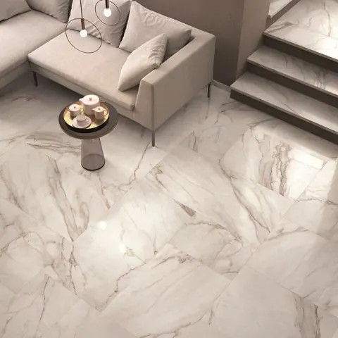 Light marble is used for the floor throughout the room, alongside comfortable seating and a restrained neutral palette.