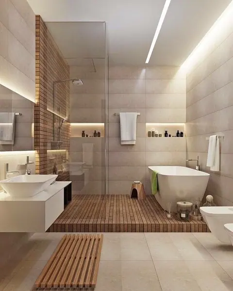 Pale veined stone is used for the bathroom walls and floor, alongside vertical timber detailing and warm concealed lighting.