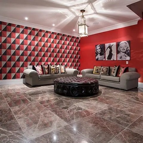 Rich brown veined stone is used for the floor throughout the room, alongside colourful furnishings and an expressive interior scheme.