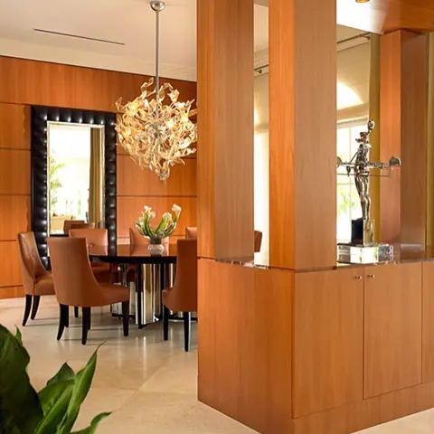 Soft cream stone is used for the floor throughout the room, alongside colourful furnishings and an expressive interior scheme.